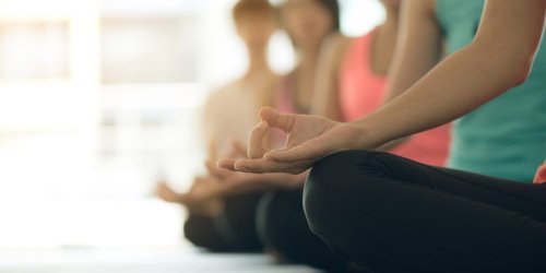 Young women yoga indoors keep calm and meditates while practicing yoga to explore the Inner Peace. Yoga and meditation have good benefits for health. Photo concept for Yoga Sport and Healthy lifestyle